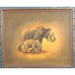 An oil on canvas showing two elephants; mother and calf, in gilt frame. Signed Buppha, 2004 bottom