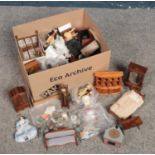 A box of assorted dolls house furniture and dolls.