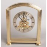 A Seiko Glass Quartz mantle clock in arched gilt surround. Small crack to back panel.