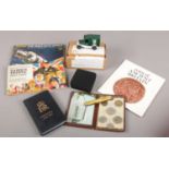 A box of collectables. Includes reproduction Coins of Ancient Britain, Brooke Bond cards, Oxford