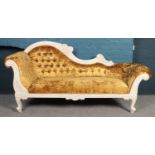 A gold crushed velvet chaise longue, with glass jeweled, deep buttoned back.