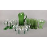 A selection of green glassware. To include a whitefriars water jug, six green French stem hocks