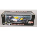 A 1:18 scale model of the 1992 Williams F1 car in original box. Bears signature Nigel Mansell on the