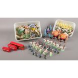 Two boxes of toy soldiers, figures and farm animals.