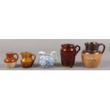 An assembly of five stone and ceramic miniature jugs. To include examples by J. Stiff & Sons and