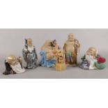 A collection of mostly Oriental bisque and glazed figures, along with a carved soapstone name seal.