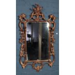 A large mirror with ornate gilt frame. Size of mirror: Height: 60cm, Width: 36cm.
