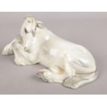 A Beswick model of a recumbent white shire horse. Chip to ear. Crack to base.