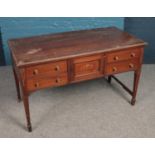 A mahogany desk with two drawers to each side and cabinet centre. (72cm x 122cm x 61cm).