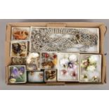 A box of costume jewellery. Includes Royal Crown Derby porcelain suites, white paste set