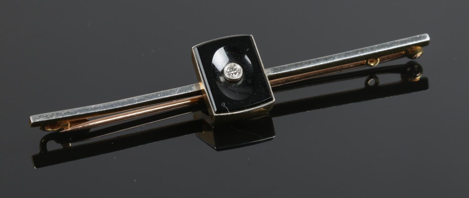 A 15ct gold and platinum diamond bar brooch. Length: 5.6cm