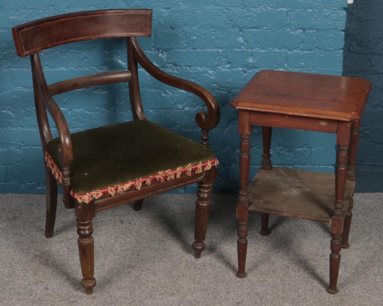 A mahogany two tier side table along with a mahogany upholstered armchair.
