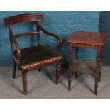 A mahogany two tier side table along with a mahogany upholstered armchair.