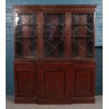 A Victorian mahogany breakfront crossbanded bookcase with cupboard base. (217cm x 184m) In need of