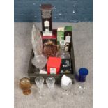 A box of mixed glass and metalwares. Includes boxed Dartington candleholder, lemonade set, silver