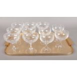 Eleven cut glass and etched champagne coupes. Comprising of a set of seven and set of four.