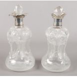 A pair of Silver topped cut glass 'glug glug' decanters. Assayed for London, 1908. One of the