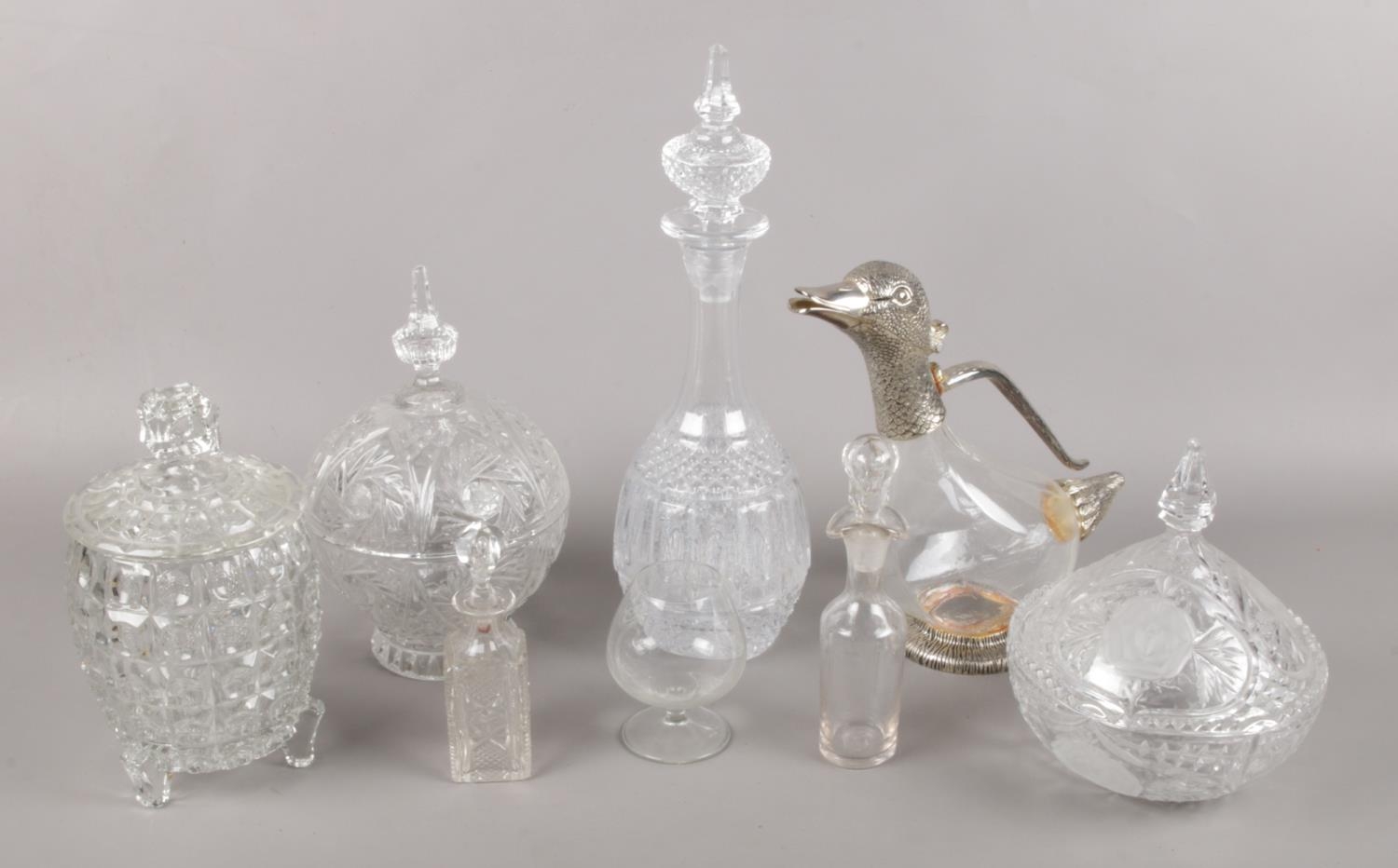 A selection of glassware. To include cut glass decanter, scent bottles and white metal topped jug in