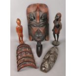 A collection of African tribal wares. Including Jambo Kenya dress mask dated 1989, wooden figure,