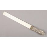 A late Victorian repoussé solid silver and ivory page turner. Handle assayed for London, 1897, by