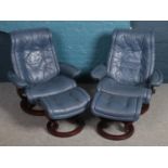 A pair of Ekornes stressless blue leather reclining armchair with matching footstools.