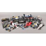 A collection of approximately 20 boxed and unboxed formula 1 cars, with examples from Minichamps,