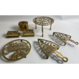 FOUR ANTIQUE BRASS TRIVETS including one with a 'Merry Christmas' message plus a small brass box 8