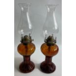 A pair of ANTIQUE brown glass reservoir 'half-size' oil lamps complete with glass funnels, height