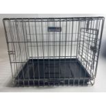 A folding metal dog cage suitable for a medium size dog, 63cm x 47cm still with its original box