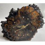 A FREE-STANDING CLOCK made from BURL WOOD STANDS APPROX 15cm high