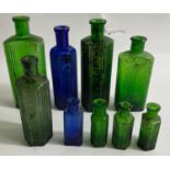 Nine vintage 'NOT TO BE TAKEN' GLASS BOTTLES in a variety of sizes from 7 - 16cm approx in both