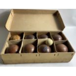 A VINTAGE set of carpet bowls in original manufacturers box RG Lawrie LTD with 8 wooden bowls and