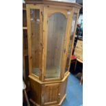 A tall 190cm pine glazed and shelved ( one) corner display cabinet with glazed door and side