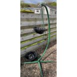 A large garden seat hanger used in a garden to hang a large seat( since disposed of) and used for