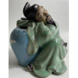 CHINESE SZECHWAN man sleeping against a large water jug approx