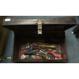 A VINTAGE TIN with old tools to include claw, a masons hammer hammers, an old hand drill etc