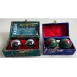 Two presentation cased CHINESE exercise balls made by the Luck Exercise Ball Factory Baoding City