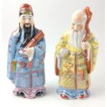 Two Oriental gentlemen in splendid robes each on a stand 16cm high approx.