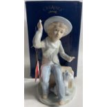 OF THE HIGHEST QUALITY! A boxed CASADES porcelain young boy and his dog figurine in its original