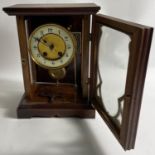 A nice EDWARDIAN ANTIQUE mahogany mantle clock with part enamel face part brass with key