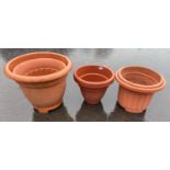 A set of 5 plastic TERRACOTTA coloured garden containers, largest height 43cm x 56cm diameter approx