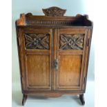 A VINTAGE Wooden hand carved cabinet which can be wall-mounted standing approx 70cm high, with