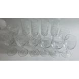 A collection of three sets of glasses, two crystal sets, large wine and champagne flute with four