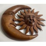 A nicely carved WOODEN SUN AND MOON wall hanging approx 25cm wide.