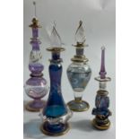 FOUR EXQUISITE, and exceedingly fragile, PERFUME BOTTLES made from Egyptian glass, the tallest