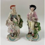 A pair of DERBY PORCELAIN FIGURINES approx 1770s manufacture, some repaired damage on the foliage