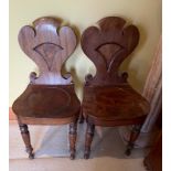 A pair of mahogany late Georgian/early Victorian HALL CHAIRS ( one leg has sustained damage but