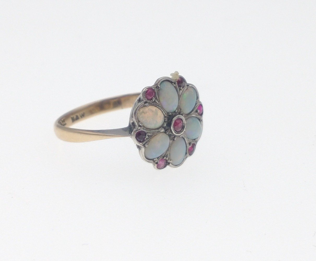 A 9ct gold opal ring with 6 opals and 7 red stones in a flower-head pattern, size M/N gross weight - Image 4 of 6