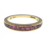 A 750 stamped yellow gold half eternity style 16 graduating ruby set RING size O, gross weight
