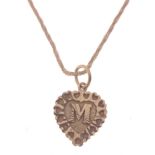 A 750 stamped yellow gold twist link CHAIN with heart shaped pendant with the letter 'M' centre,